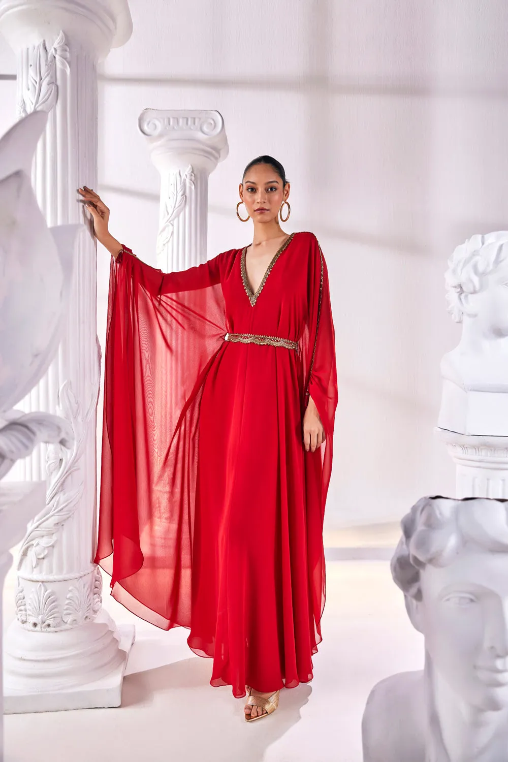 Long Kaftan Designed In A Royal Georgette Fabric Features A Plunging Neckline With Beautiful Intricate Hand Embroidery Along With An Embroidered Belt.