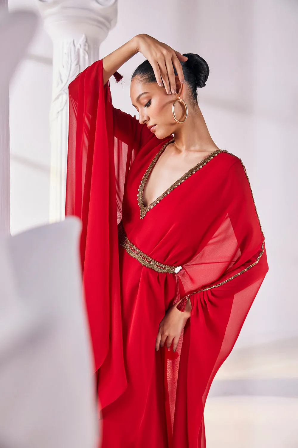 Long Kaftan Designed In A Royal Georgette Fabric Features A Plunging Neckline With Beautiful Intricate Hand Embroidery Along With An Embroidered Belt.