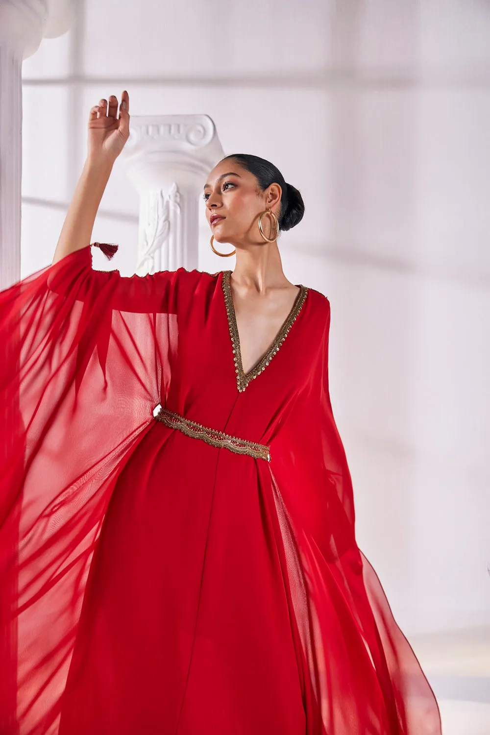 Long Kaftan Designed In A Royal Georgette Fabric Features A Plunging Neckline With Beautiful Intricate Hand Embroidery Along With An Embroidered Belt.